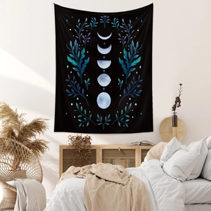 Detail of bohemian black moon phase tapestry with blue floral patterns on bedroom wall
