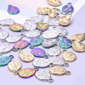 Detail of rose embossed oval charms in gold, silver and iridescent 18k plated steel