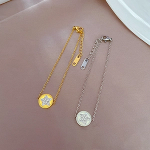 Titanium steel bracelet featuring a crystal star disc pendant in gold and silver finish