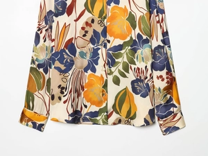 Close-up of artistic floral print long sleeve satin shirt showing cuff and button details