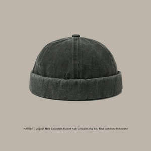 Detail of dark grey washed denim docker hat with six-panel structure and thick brim