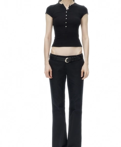 Close-up of slim fit black crop Henley top with shell buttons and matching trousers
