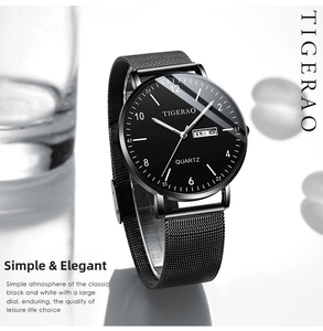 Detail of minimalist quartz watch with dual calendar display and black mesh strap
