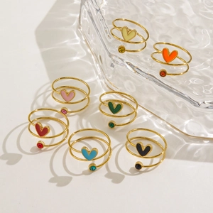 Set of seven gold spiral open rings with colorful enamel hearts and sparkling rhinestones