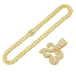 Hip hop gold Cuban link chain with a sparkling iced-out heraldic fleur-de-lis pendant