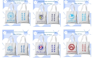 Detailed view of white canvas tote bags with various university logos and slogans.
