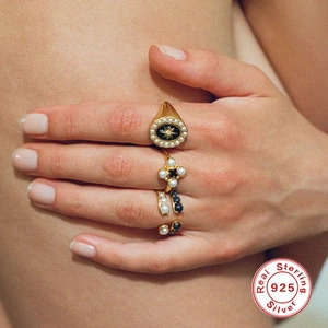 Stacking set of four gold 925 sterling silver rings with pearls and starburst motifs