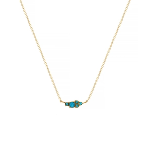 Detailed close-up of a 18k gold plated necklace with a round blue sapphire pendant
