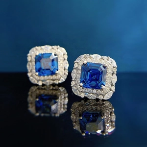 Royal blue square sapphire earrings with double halo diamond setting and mirror reflection