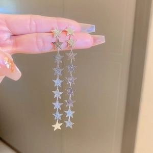 Detailed view of silver star tassel earrings with multiple linked pentagram pendants
