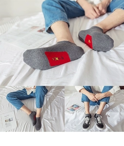 Grey cotton low cut socks for men featuring a distinctive red sole and graphic pattern