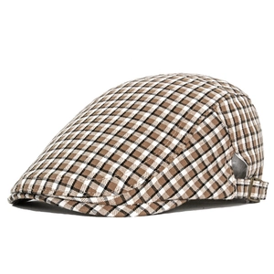 Detail of British plaid beret featuring bronze adjustable metal buckle and fine texture
