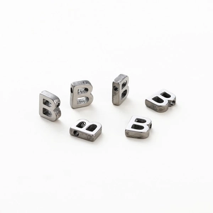 Close-up of six silver metal letter B beads with 1.8mm holes for DIY jewelry making