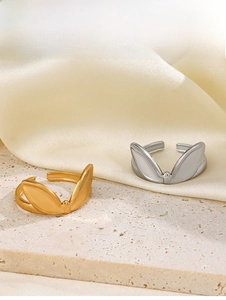 Detail of adjustable bunny ear rings in gold and silver finish on silk fabric