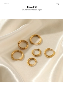 Three pairs of polished gold hoop earrings in different sizes on white satin fabric