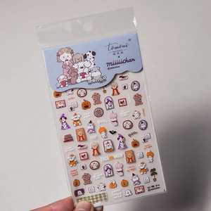 Detail view of thin Halloween nail stickers with cartoon dogs and pumpkin designs