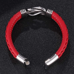 Close-up of red braided leather bracelet featuring a silver metal knot and magnetic clasp