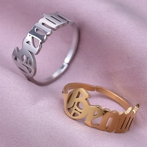 Detailed view of adjustable open-ring band in polished gold and silver finishes