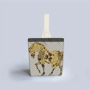 Detail of artistic tote bag featuring an intricate horse pattern and canvas texture