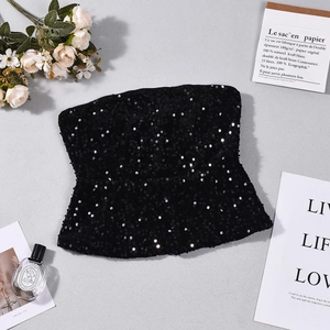 Flat lay of black sequin bustier top with leopard textures and stylish fashion props