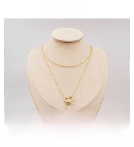 Detailed view of a layered gold titanium necklace with an open heart pendant on a bust stand