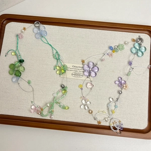 Floral beaded necklace with glass crystal bow in fresh green and purple tones