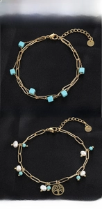 Detail of titanium steel bracelets with turquoise beads, pearls and tree of life charm