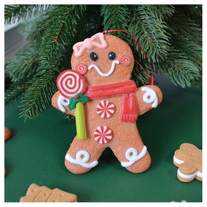 Detailed view of gingerbread man Christmas tree ornament with red scarf and candy decor