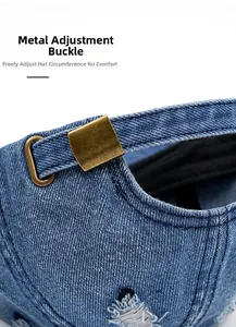 Close-up of adjustable metal buckle and distressed denim texture on a baseball cap