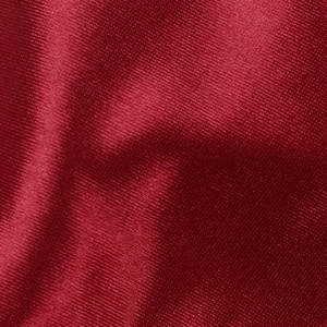 Detailed macro view of dark red satin fabric with smooth glossy finish and fine texture