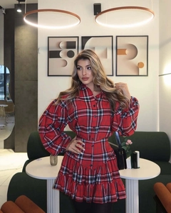 Detailed view of red plaid skirt with ruffle hem and premium fabric texture detail