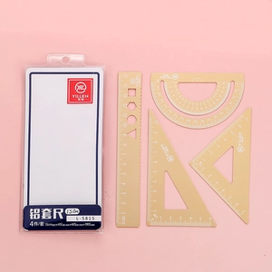 Macro view of golden aluminum alloy ruler set including protractor and triangles