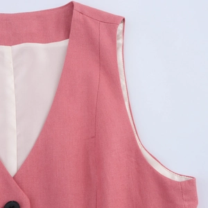 Detail of pink vest jacket showing high-quality linen texture and black button detail