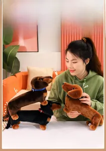 Detailed view of three colorful dachshund plush toys with collars held by a model