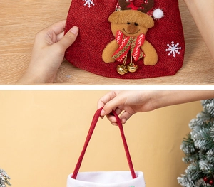 Detail of red Christmas reindeer gift bag with 3D applique, bells, and snowflake embroidery