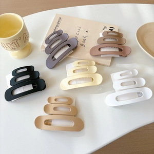 Set of 6 matte hair claws with triple-layer cutout design in assorted neutral colors