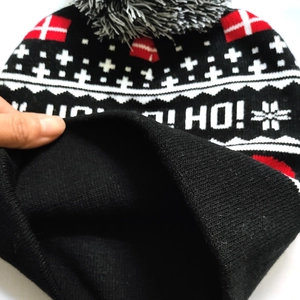 Detailed close-up showing the thick black thermal fleece lining of the knit Christmas hat