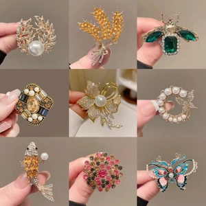 Variety set of 9 elegant alloy brooches featuring pearls, crystals, and animal designs