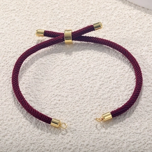 Detail of red Milan cord bracelet with adjustable gold-plated slider and metallic ends