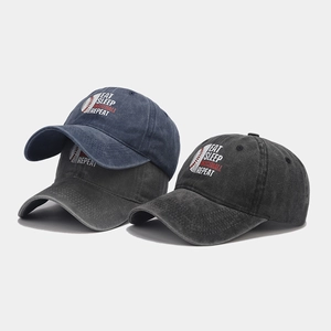 Washed cotton baseball caps in blue, grey, and black with embroidered baseball slogan