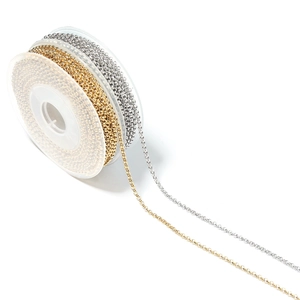 Macro shot of gold and silver plated stainless steel chains on spool for jewelry making