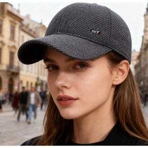 Detail of dark grey winter baseball cap featuring knit texture and sport-58 side patch