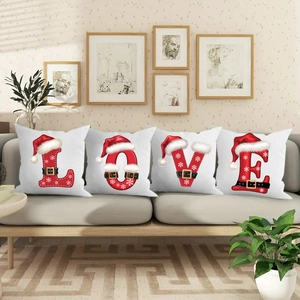 Detailed view of 4-piece set of red and white Christmas LOVE letter pillow covers on sofa