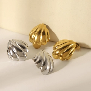 Polished 18k gold and silver scallop shell stud earrings set in a minimalist layout