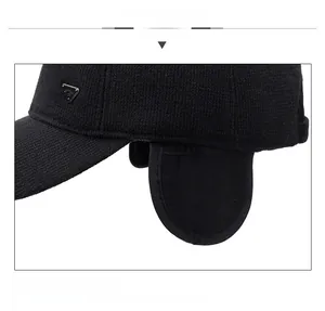Detailed close-up of winter baseball cap with ear flaps and metal triangle accent