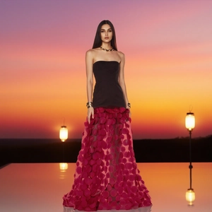 Detail of elegant strapless dress featuring layered magenta 3D petal mesh long skirt