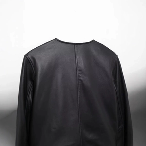 Back view of a cropped black leather jacket featuring premium texture and fine stitching