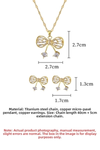 Macro detail of gold butterfly cherry jewelry set with dimensions for steel necklace