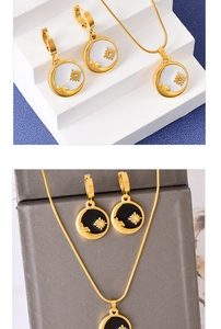 Detail of sun and star enamel jewelry set with earrings and pendant necklace