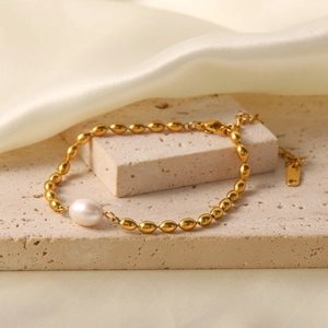 Golden titanium steel beaded bracelet featuring a white natural freshwater pearl on stone